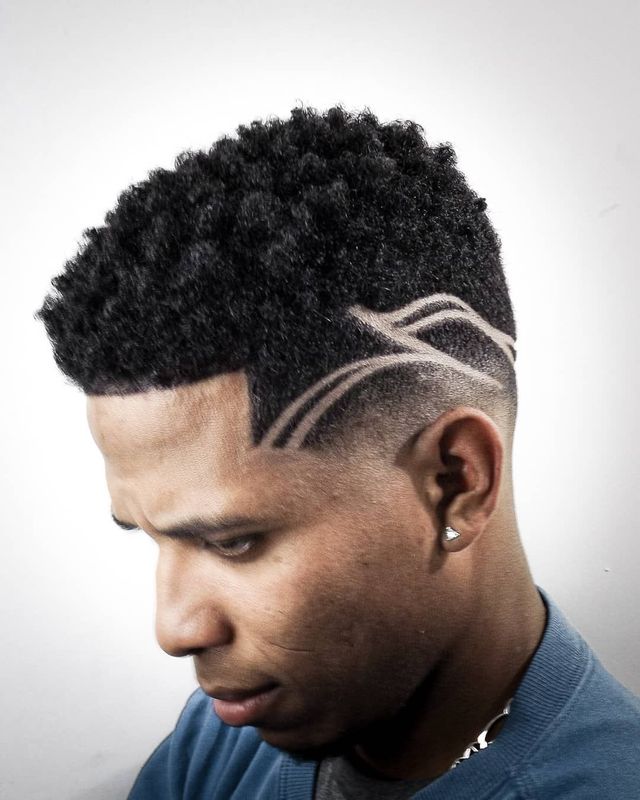 Curly top fade with freehand hair tattoo design