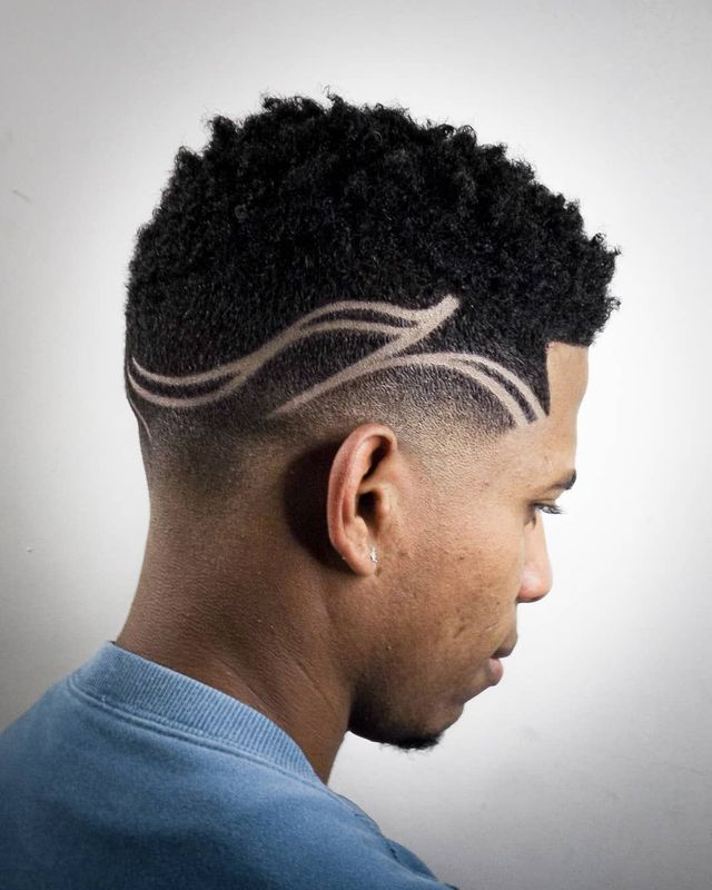 Curly top fade with freehand line design, side view