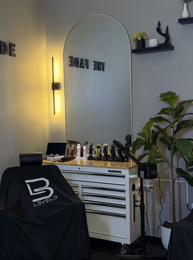 Barber station with THE FADE lettering reflected in arched mirror