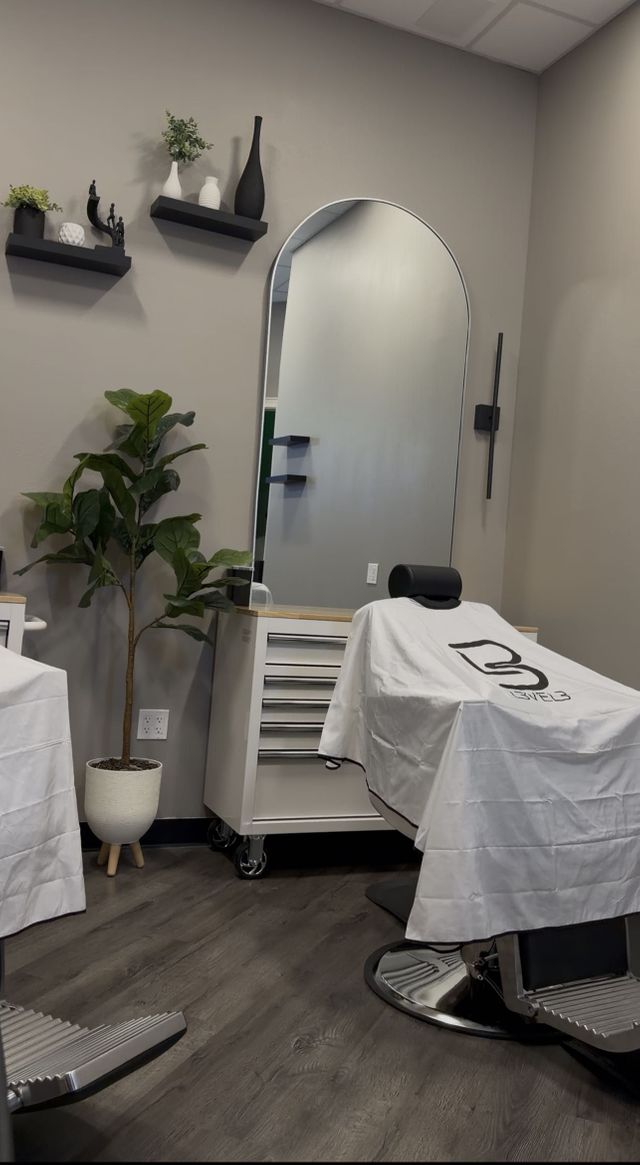 Two barber stations with plants and decor shelves